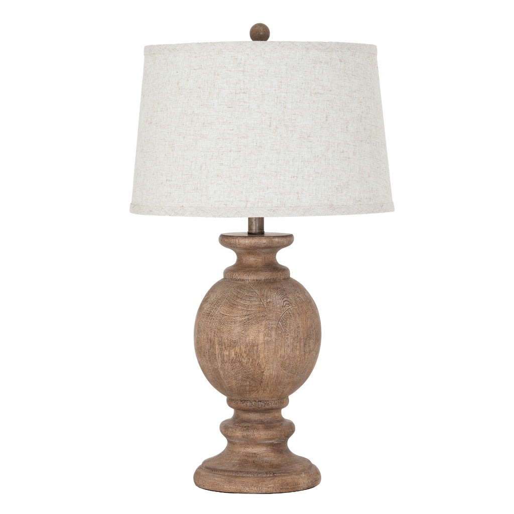 Table lamp with wooden base and white shade on a white background