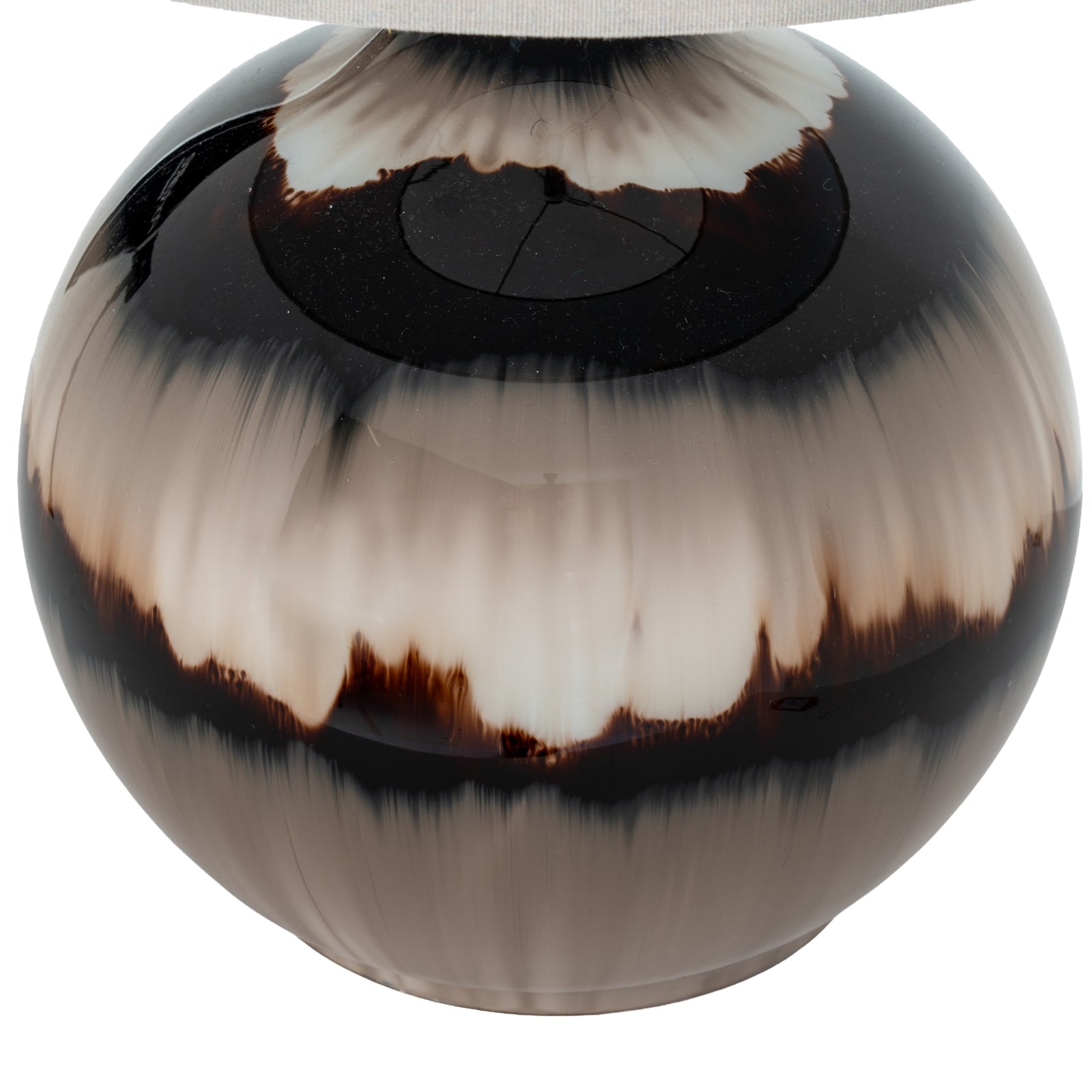 Round decorative object with black and white pattern on a white background