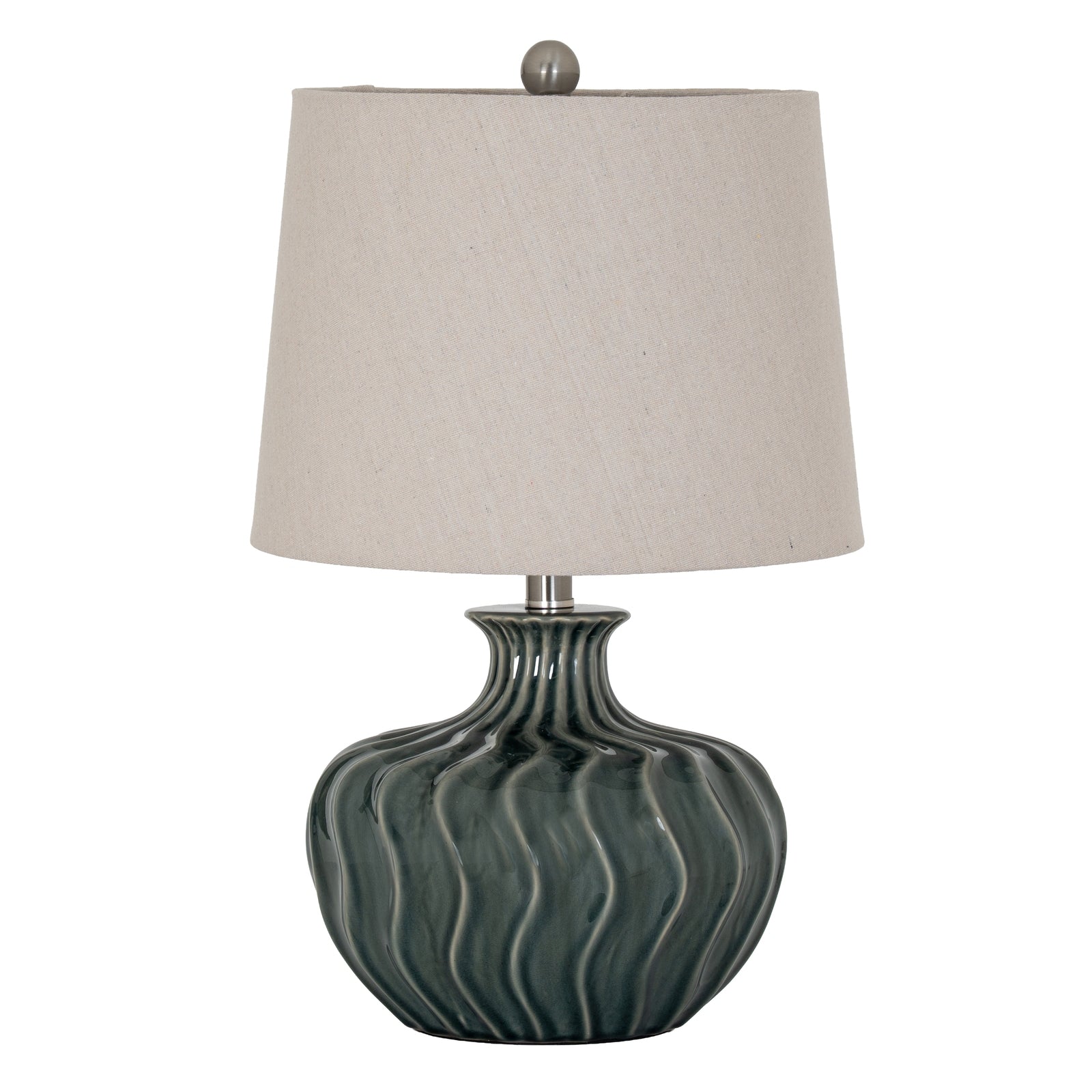 Table lamp with wavy green base and beige lampshade on a white background