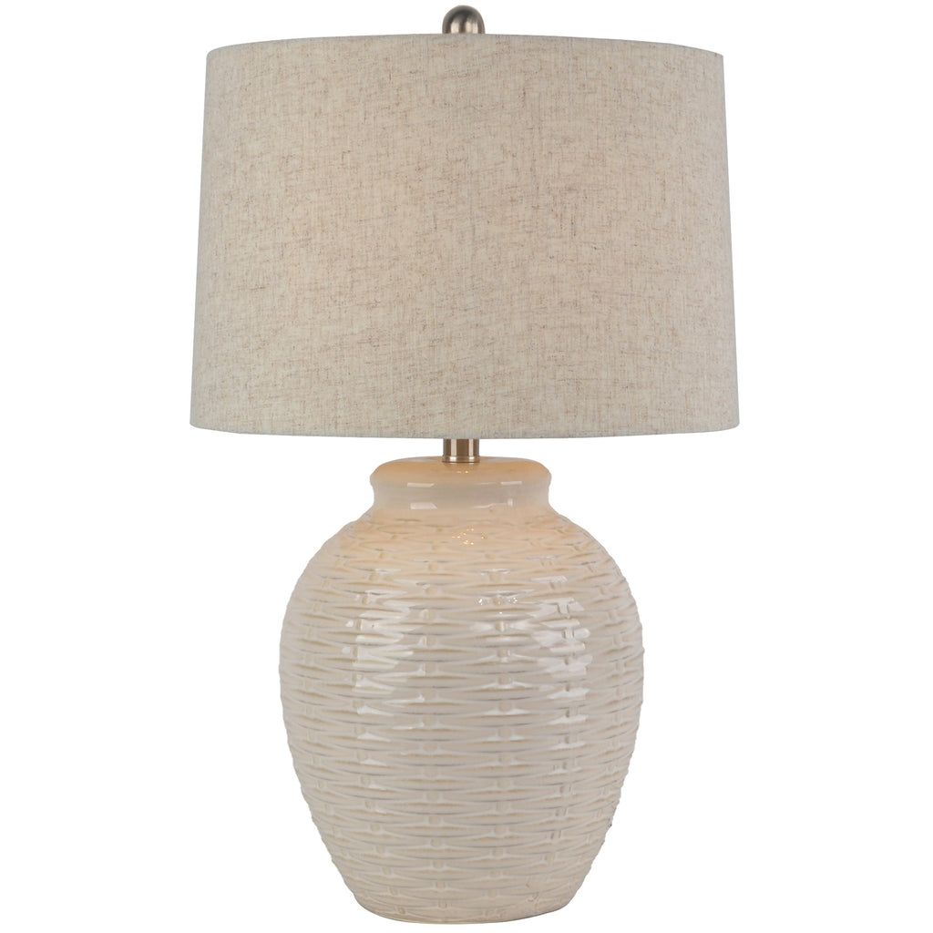 Table lamp with textured beige base and shade on a white background