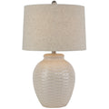 Table lamp with textured beige base and shade on a white background