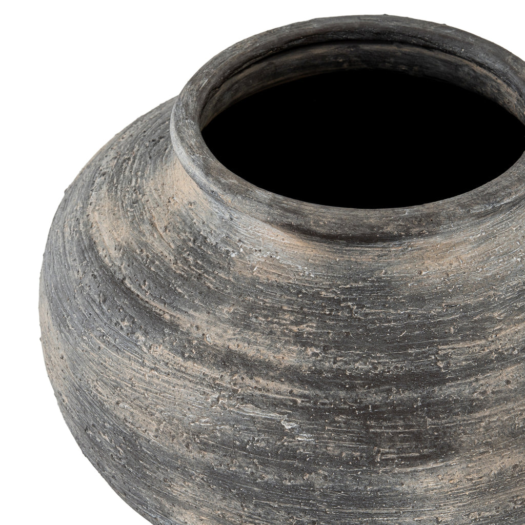 Close-up of a textured black pot on a white background