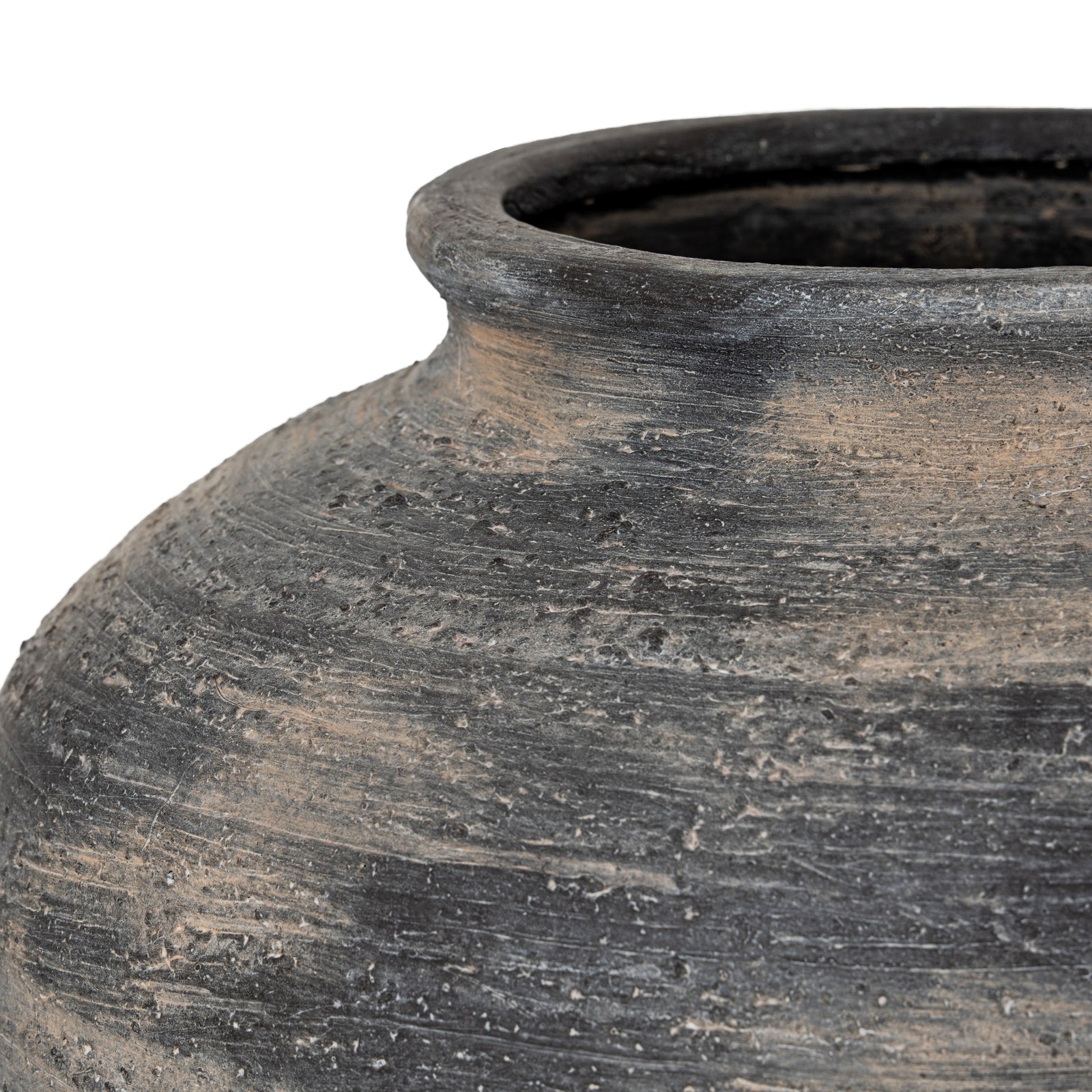 Close-up of a textured black ceramic pot on a white background