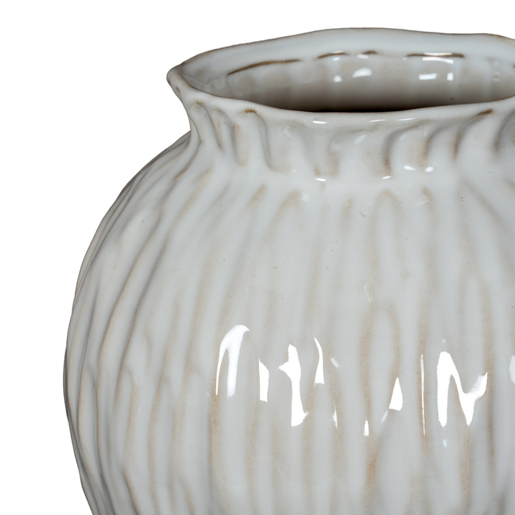 White ceramic vase with ribbed texture on a white background