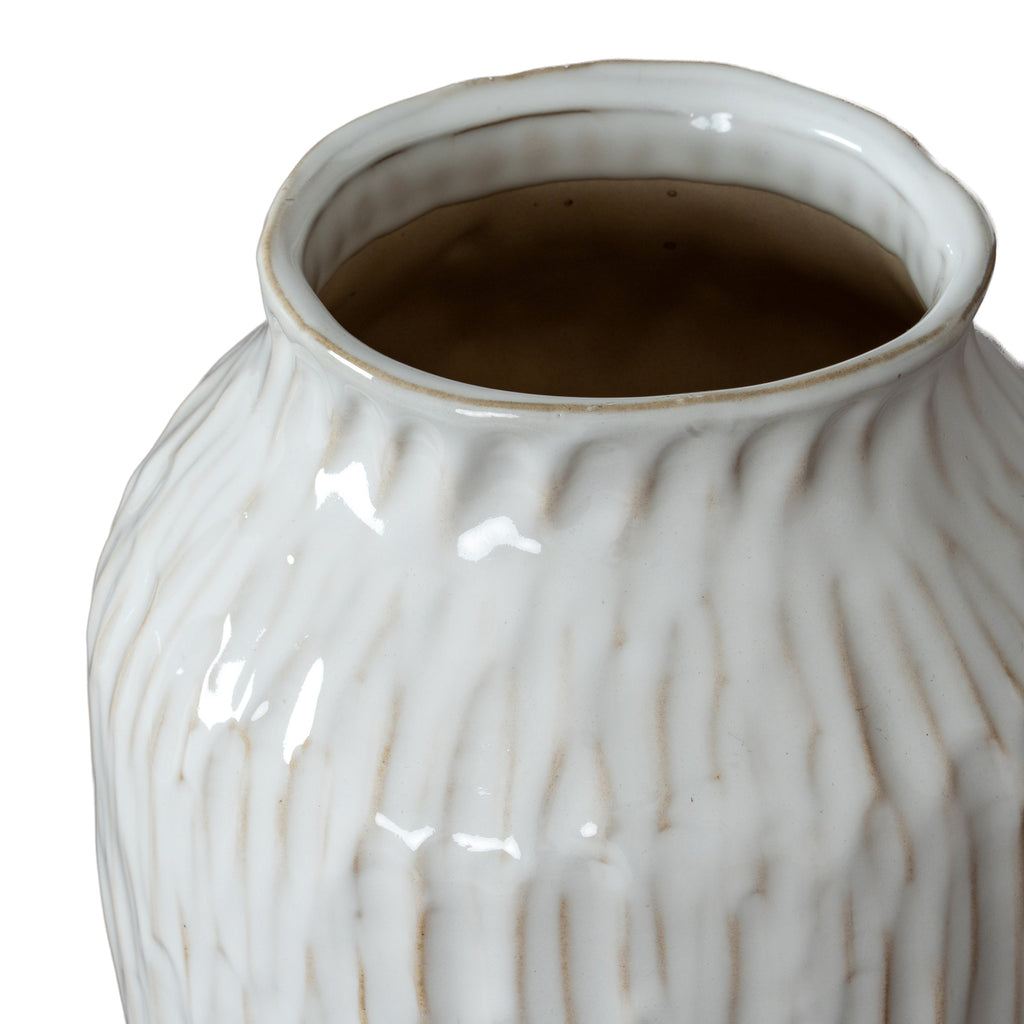 White ceramic vase with textured surface on a white background