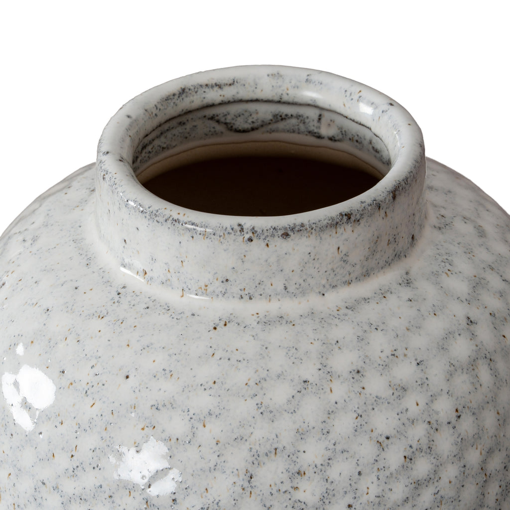 Close-up of a textured ceramic vase on a white background