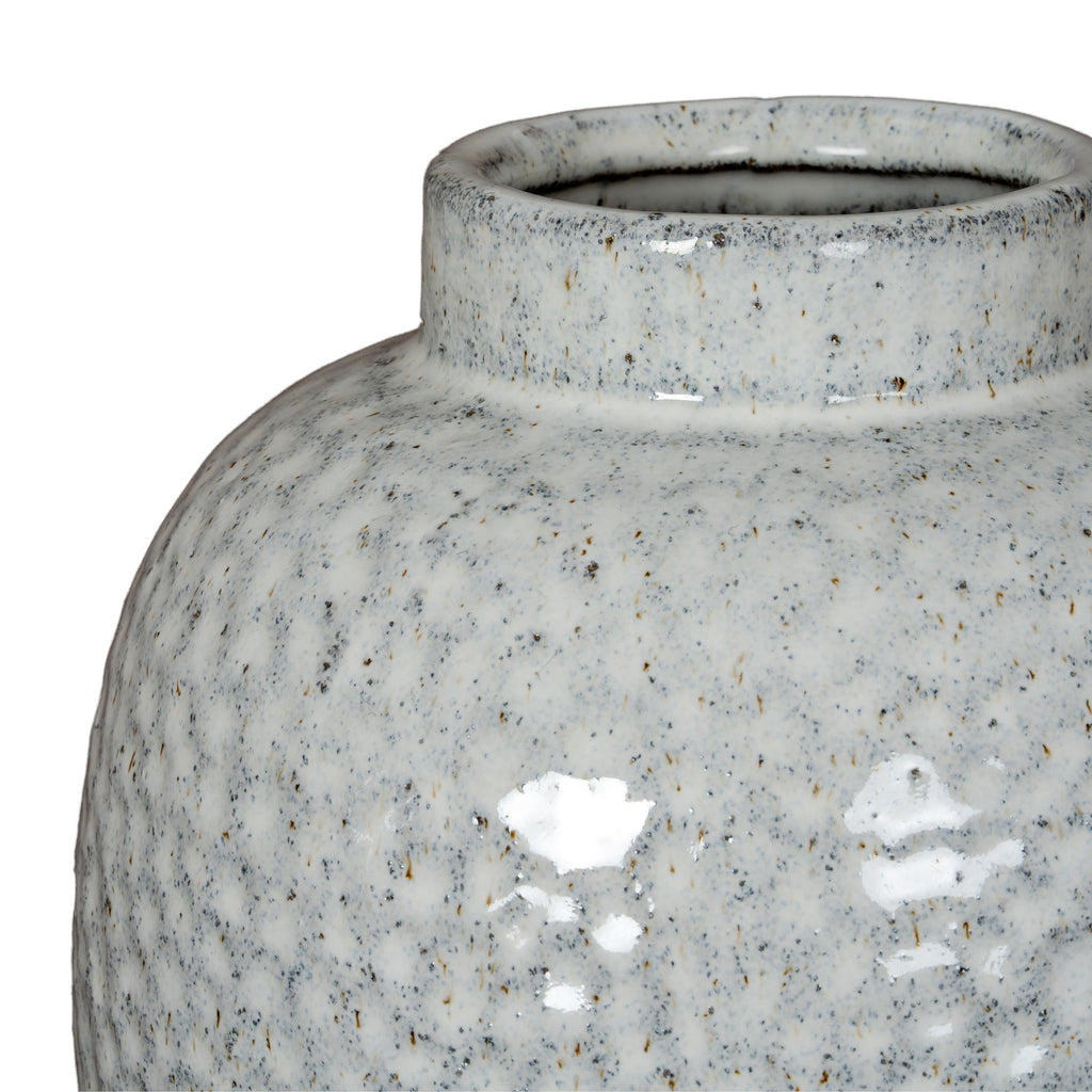 Close-up of a textured gray ceramic jar on a white background