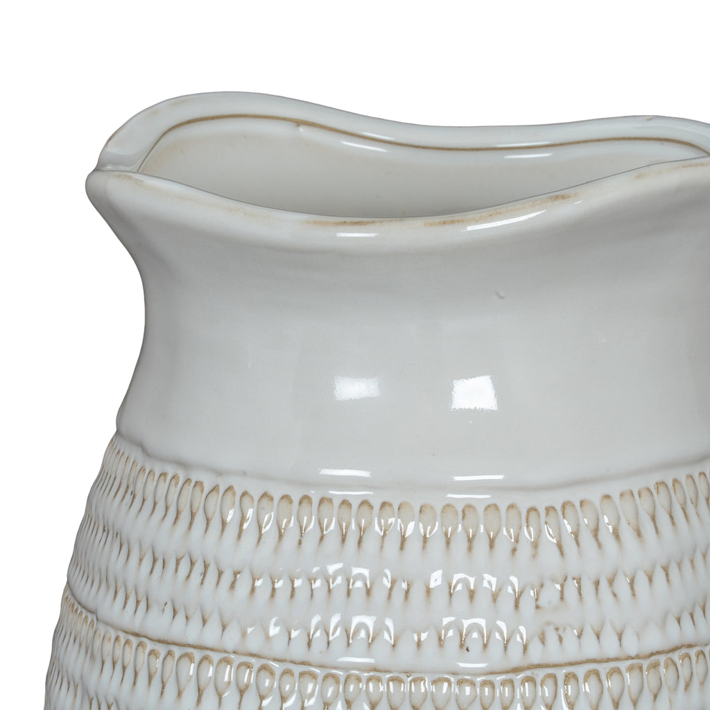 Close-up of a white ceramic vase with textured design on a white background