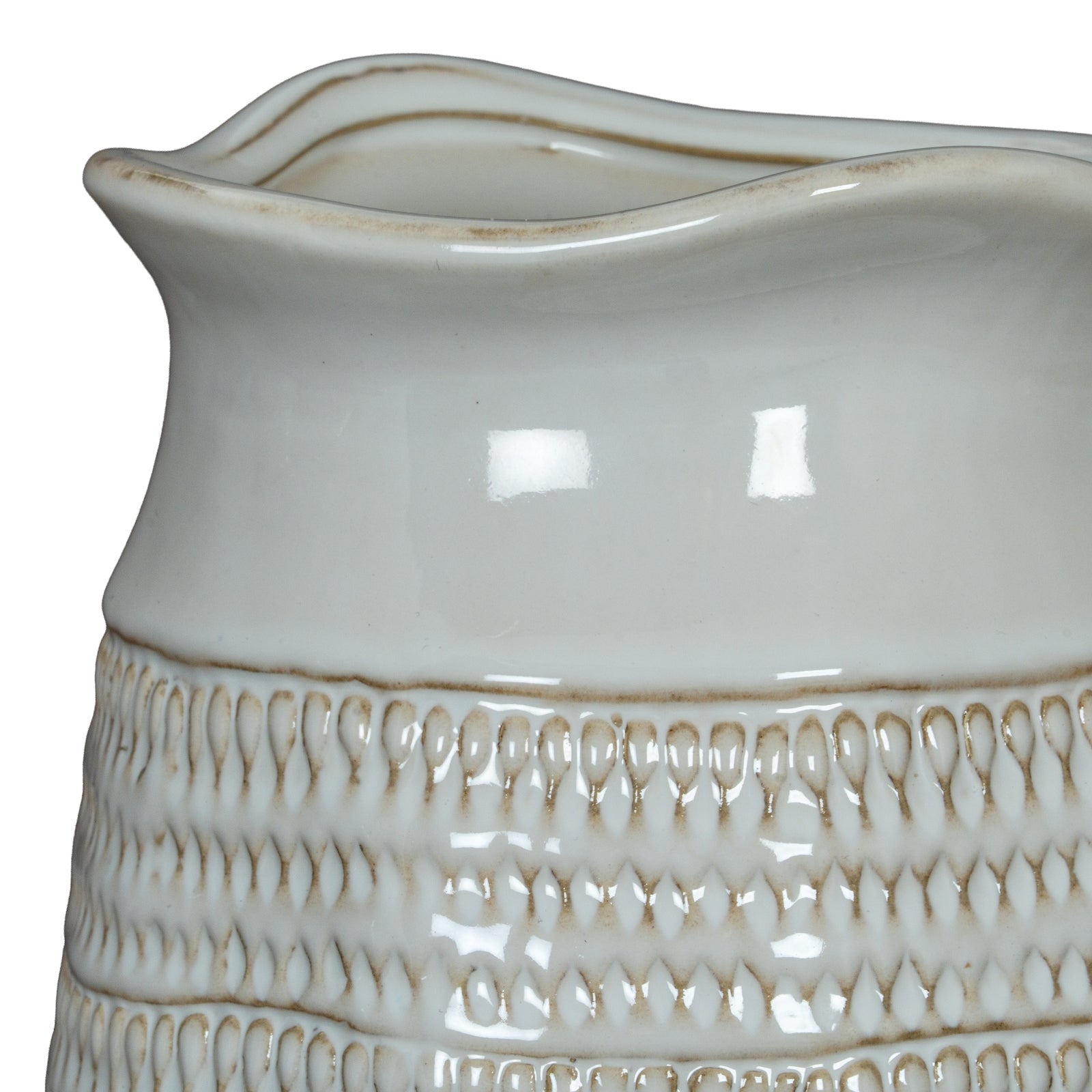 Close-up of a ceramic pitcher with textured design on a white background