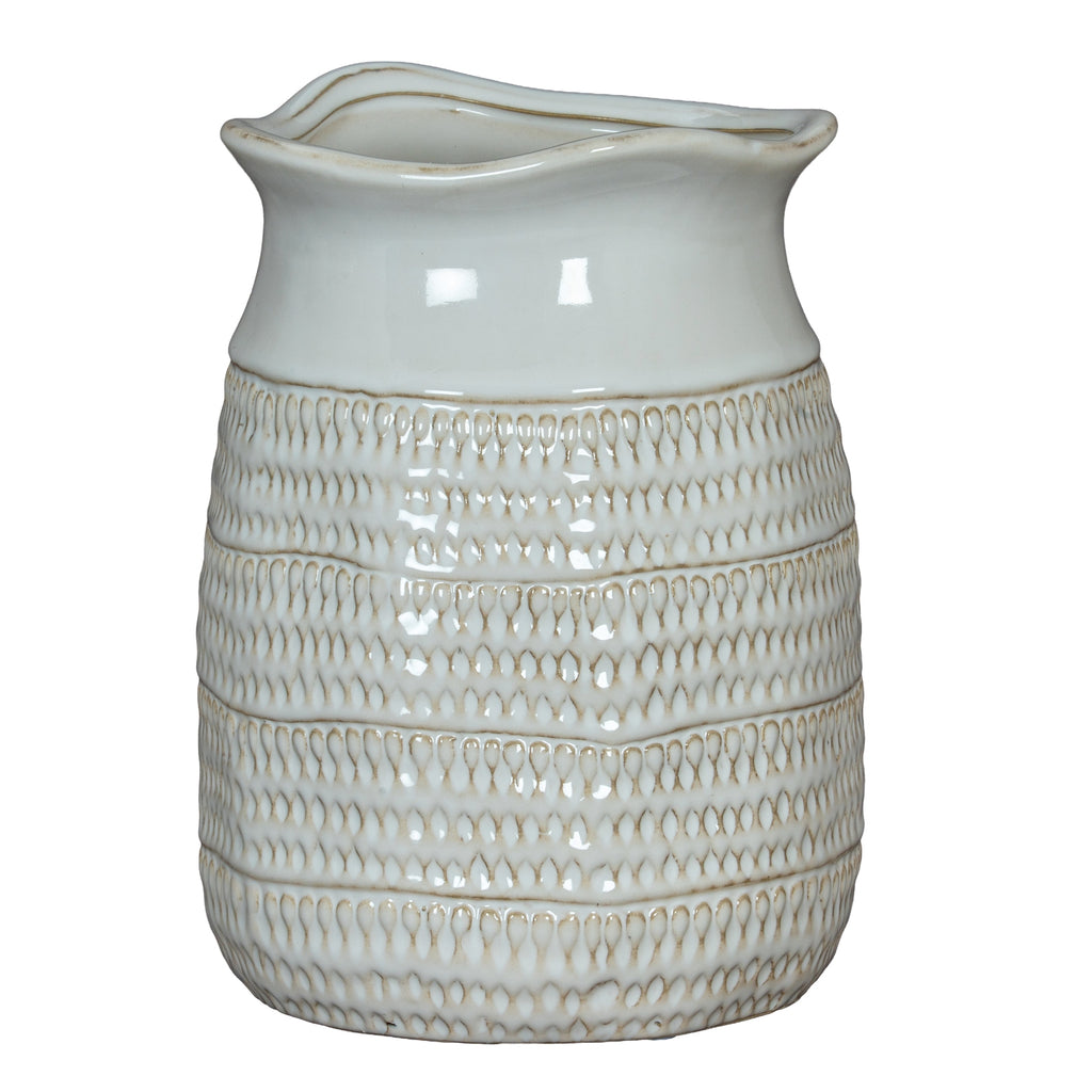 White ceramic pitcher with textured design on a white background