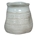 White ceramic vase with textured design on a white background