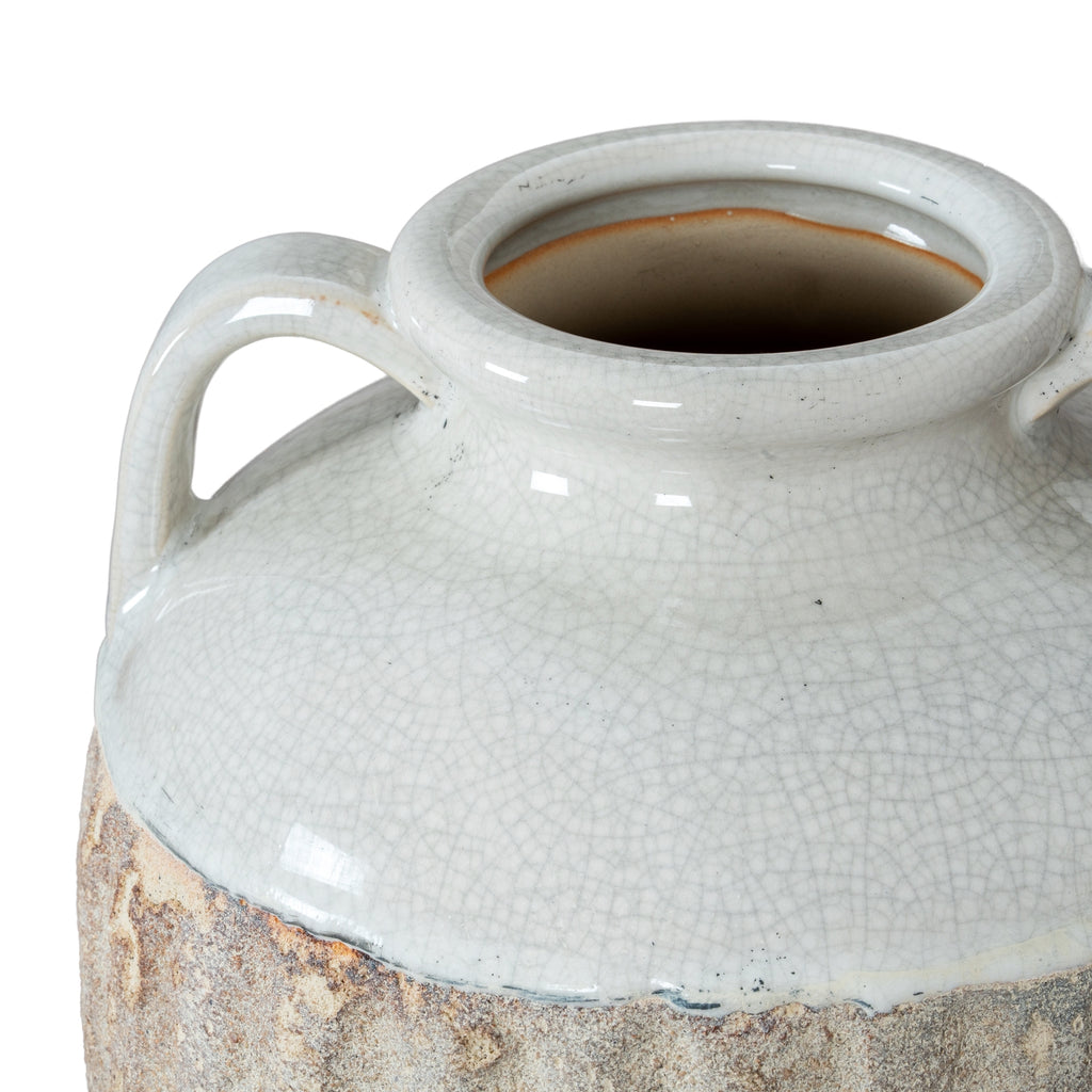 White ceramic jar with textured surface and handles on a white background