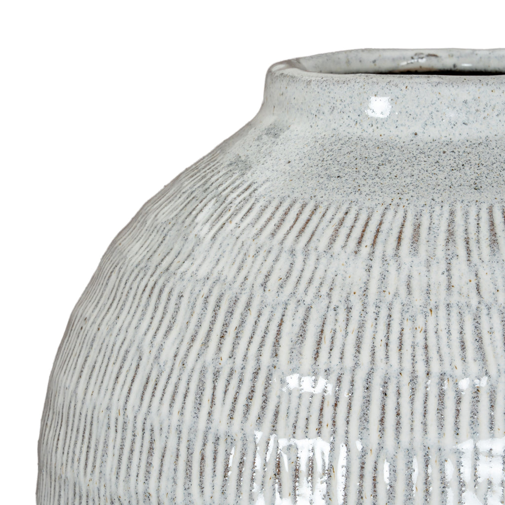 Close-up of a textured ceramic vase on a white background