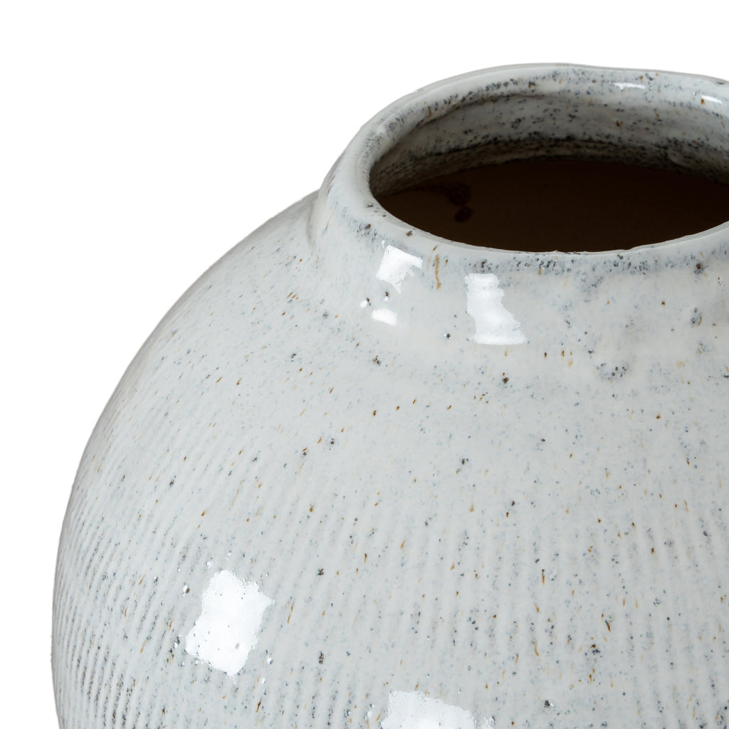 Close-up of a textured ceramic vase on a white background