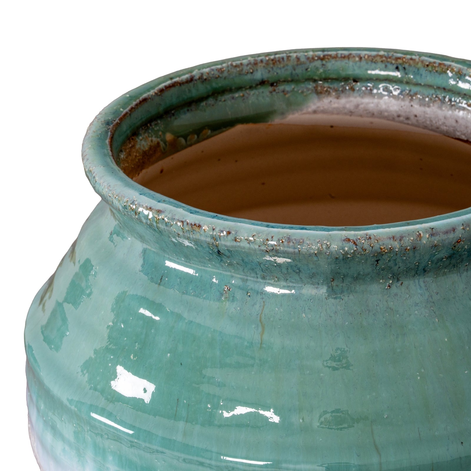 Close-up of a teal ceramic pot with a textured surface on a white background