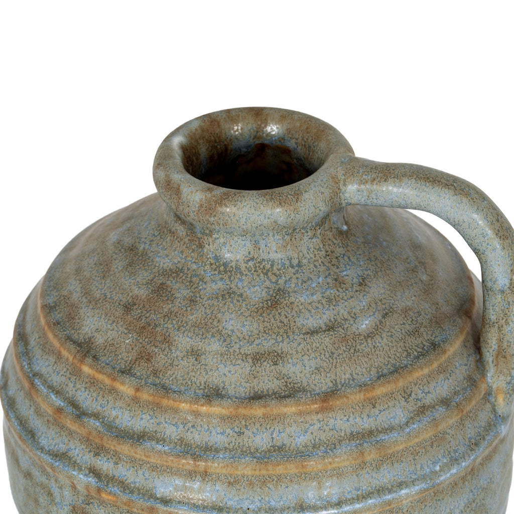 Vintage-style ceramic jar with a handle on a white background