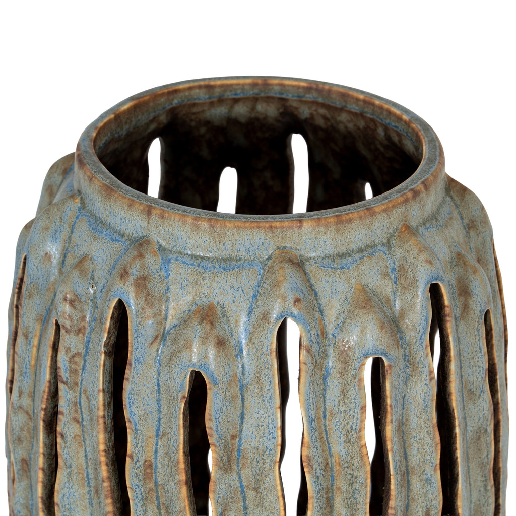 Decorative ceramic vase with textured surface and cut-out patterns on a white background