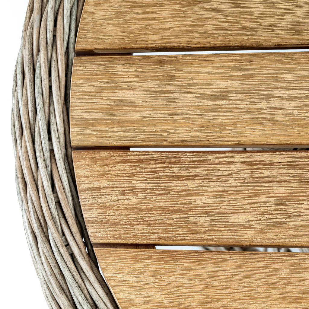 Close-up of a wooden chair with woven armrests on a white background