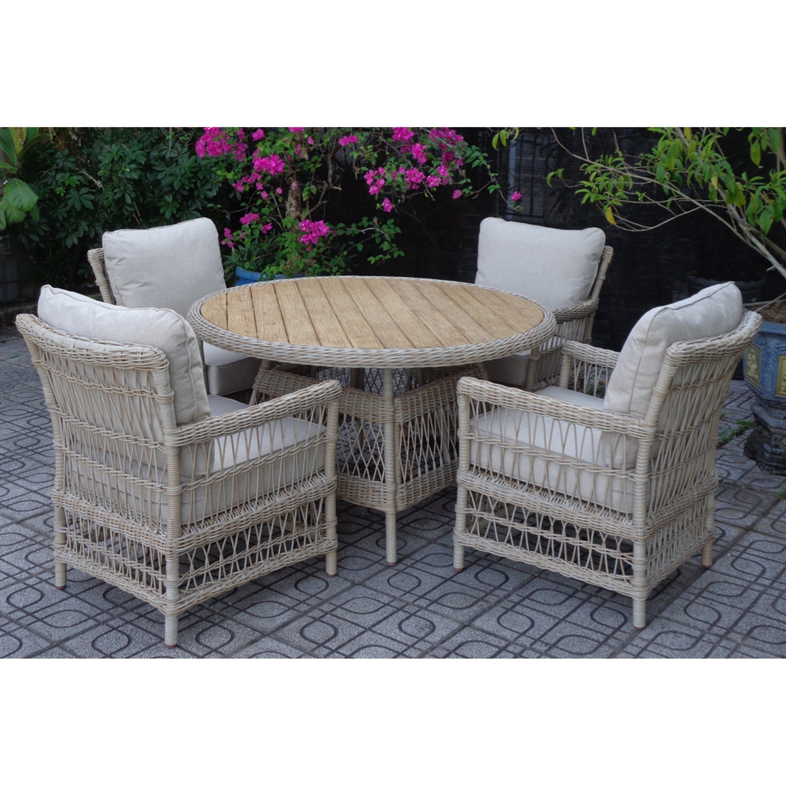 Wicker outdoor furniture set with round table and chairs on a patio