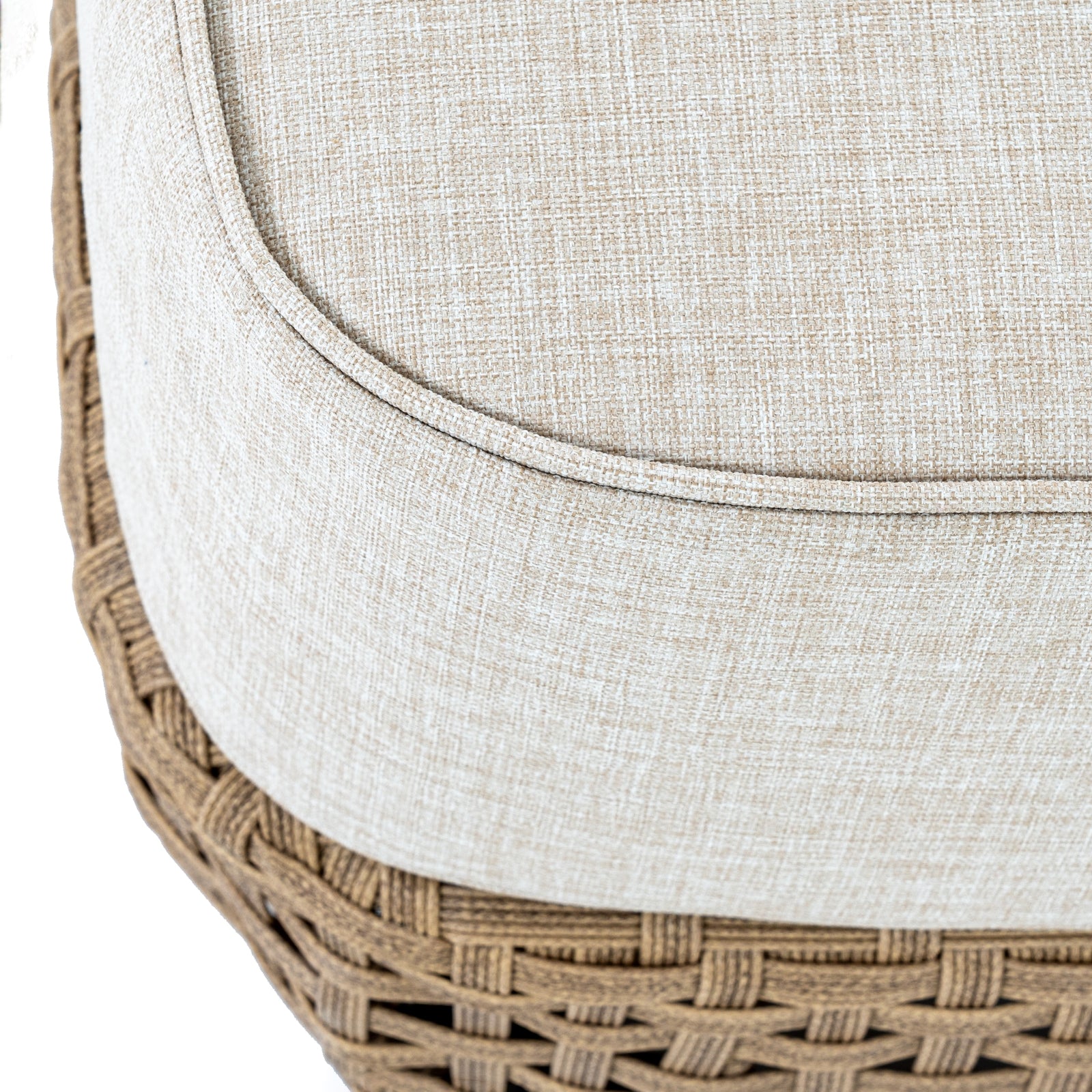Close-up of a woven ottoman with a beige cushion